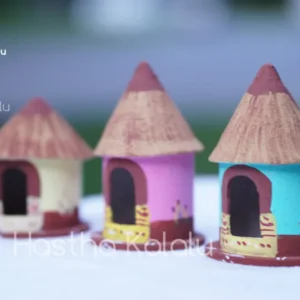 A collection of handmade wooden huts painted in various colors, typically found in Kondapalli, India, used as show pieces during cultural festivals.