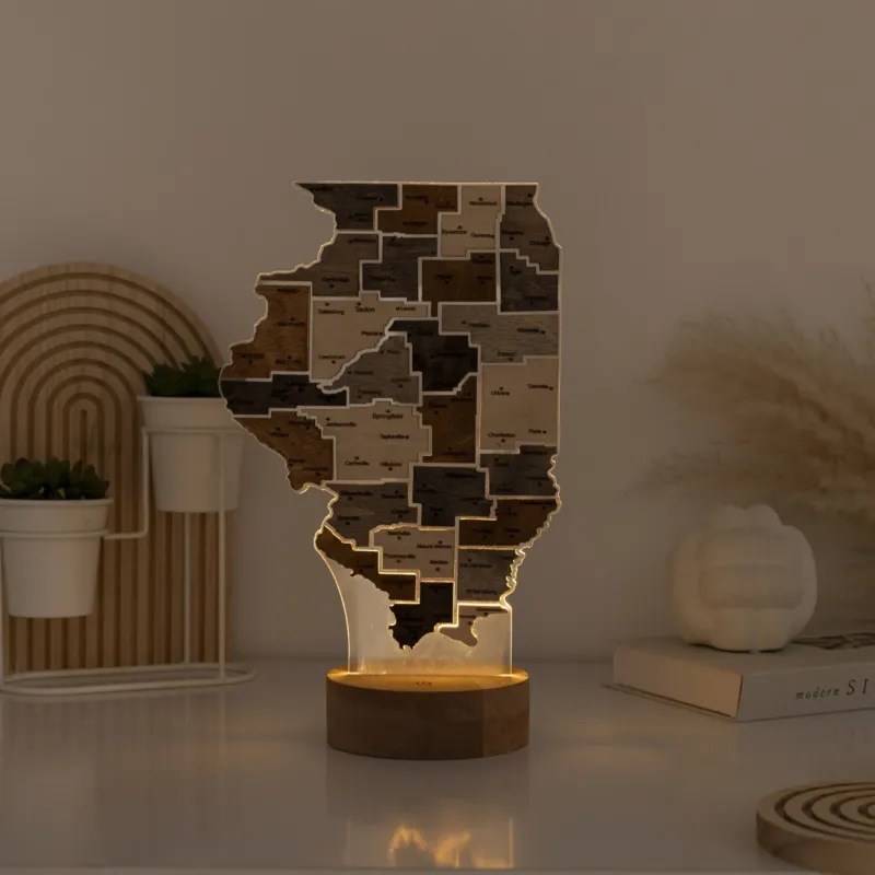 Wooden lamp shaped like a state with a warm glow on a table.