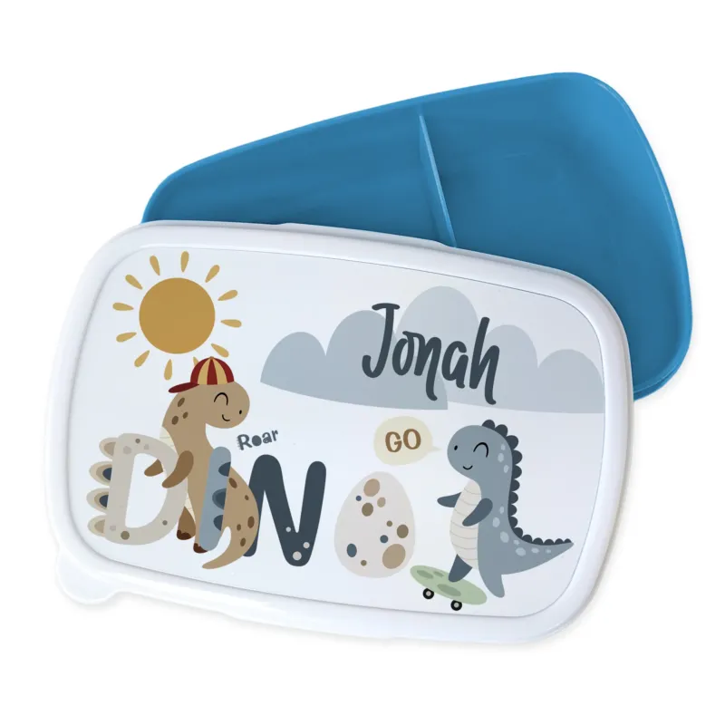 Bento-Box mit Dinosaurier-Motiv und blauer Innenseite.