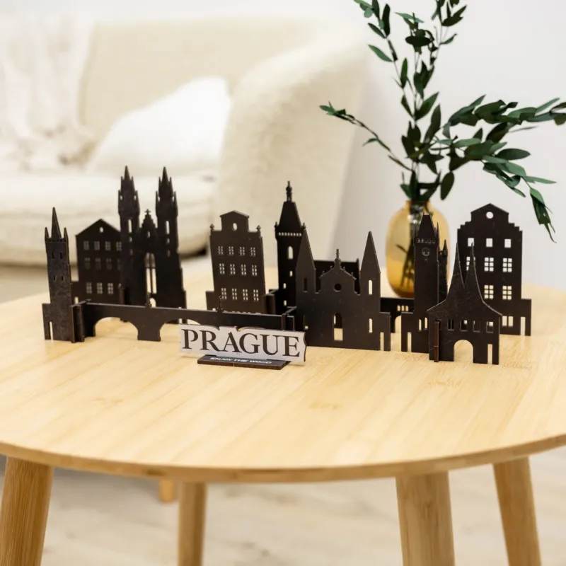 Model of Prague skyline on a wooden table with a plant in the background