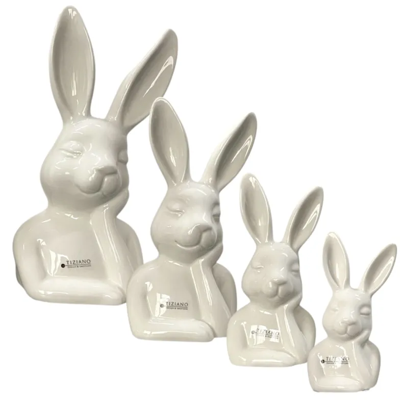Vier Osterhasen Deko Büsten aus creme weißer Keramik in vier Größen. Der Osterhase stützt sein Gesicht auf der Hand ab und schaut zufrieden.